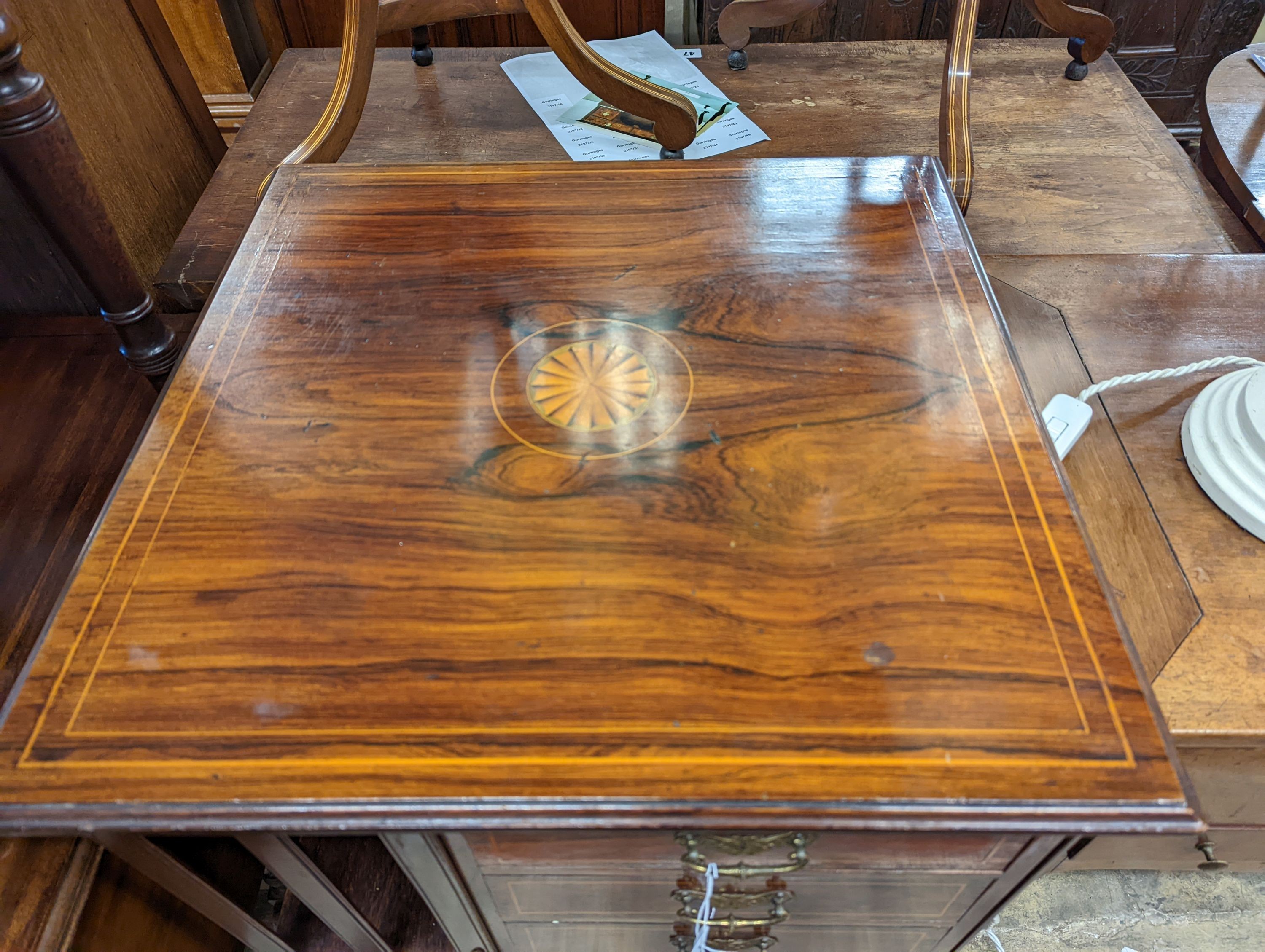 An Edwardian inlaid rosewood revolving bookcase fitted three drawers, width 52cm, depth 51cm, height 88cm